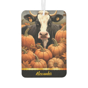 A playful cow amidst colourful pumpkins in autumn car air freshener