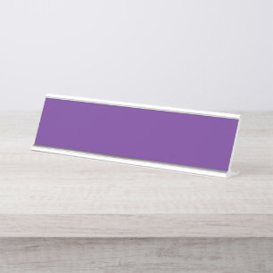 a purple background with a white border desk name plate