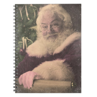 A Real Vintage Santa Claus checking out his list Notebook