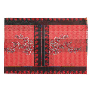 a red and black pattern with flowers on it pillowcase