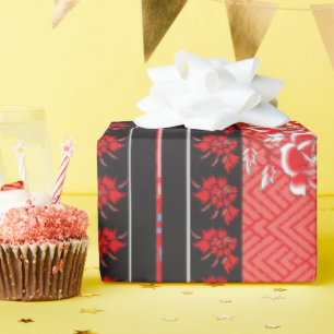a red and black pattern with flowers on it wrapping paper