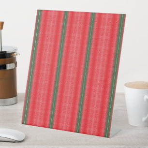 a red and green striped background pedestal sign