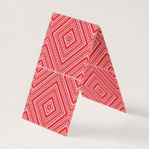 a red and white background with a diamond pattern business card