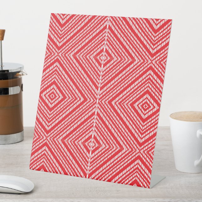 a red and white background with a diamond pattern pedestal sign (In SItu)
