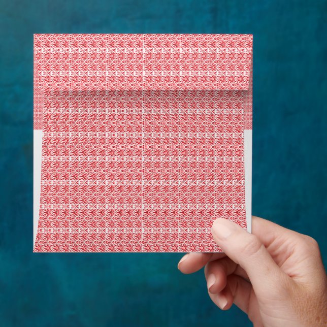 a red and white background with a pattern envelope (Hand)
