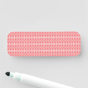 a red and white background with a pattern name tag