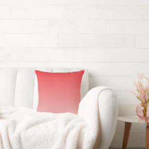 a red and white background with small squares cushion