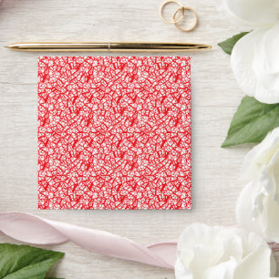 a red and white background with small white dots envelope