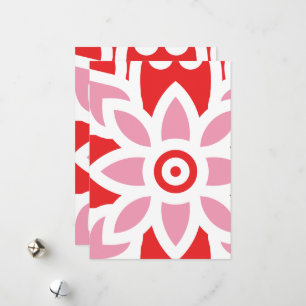 a red and white pattern with a flower on it holiday card