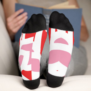 a red and white pattern with a flower on it socks