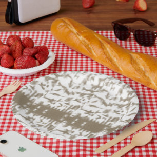A red and white Swiss flag waves under a clear blu Paper Plate