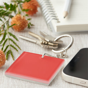 a red background with a white border key ring