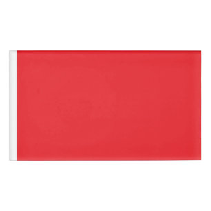 a red background with a white border name tag