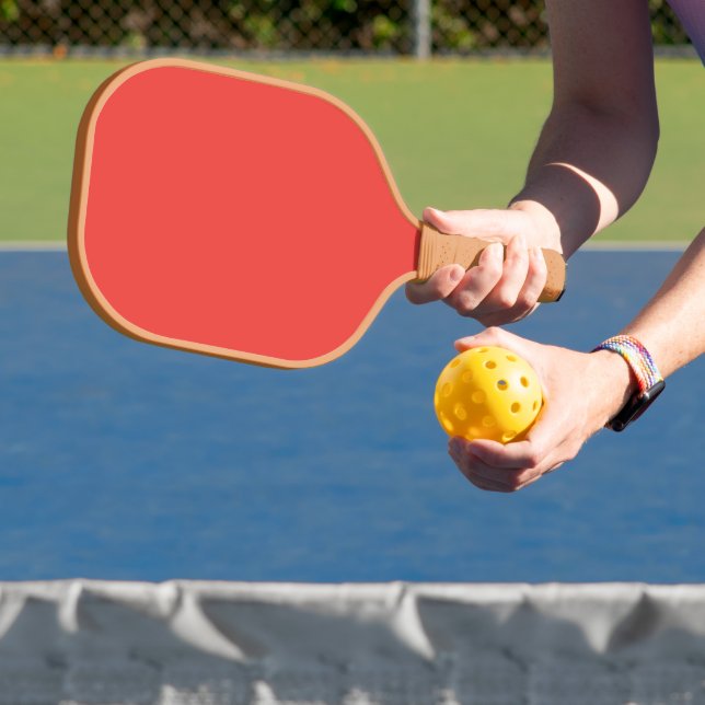 a red background with a white border pickleball paddle (Insitu)