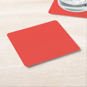 a red background with a white border square paper coaster