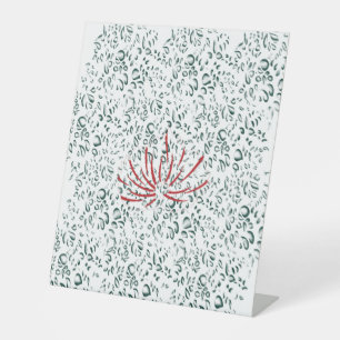 a red flower on a black background pedestal sign
