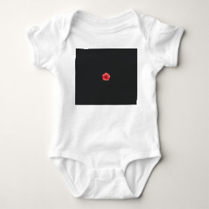 a red flower with a black centre on a black backgr baby bodysuit