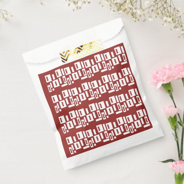 A red rug with a textured pattern is spread out on favour bags (Sealed)