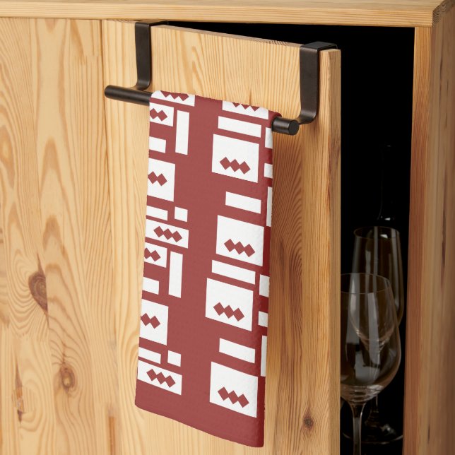 A red rug with a textured pattern is spread out on tea towel (Thirds Fold)