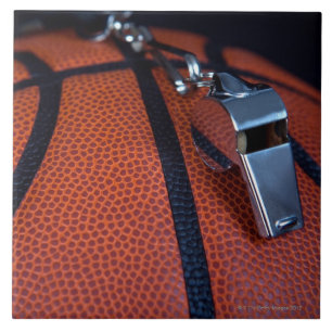 A referee's whistle rests on top of a tile