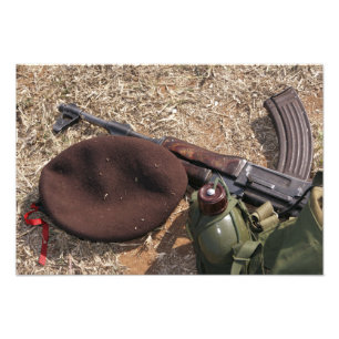 A rifle, military cover and canteen photo print