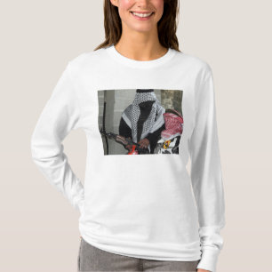 A role-playing enemy aggressor arms a dummy T-Shirt