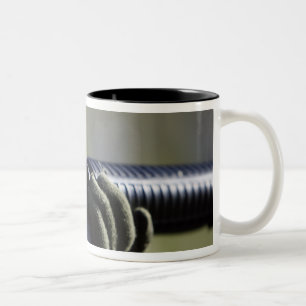 A round flies from the chamber of an M-16A2 Two-Tone Coffee Mug