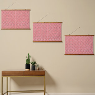A rug with a red and pink motif features a decorat hanging tapestry