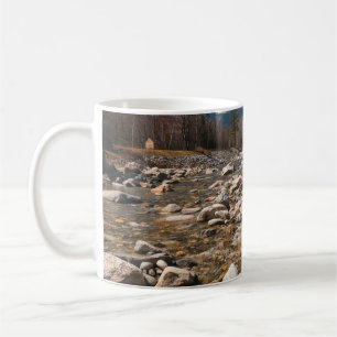 A running stream river with clear water flowing wi coffee mug