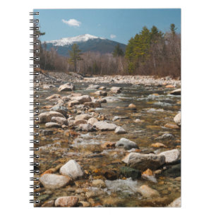 A running stream river with clear water flowing wi notebook