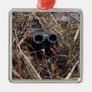 A scout observer practices observation techniqu 2 metal tree decoration
