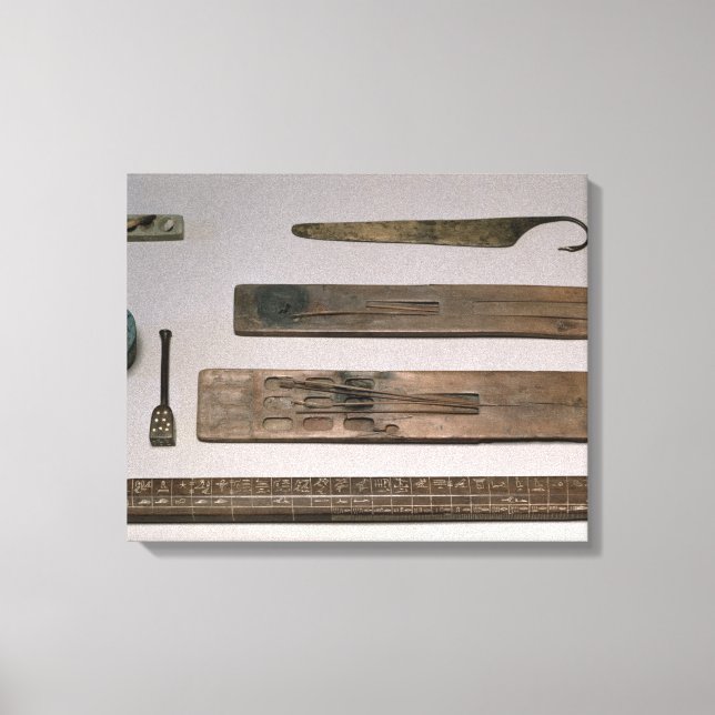 A scribe's instruments (wood, ivory, bronze and en canvas print (Front)