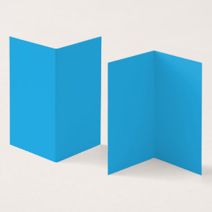 A serene blue sky with a few scattered white cloud