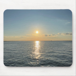 A serene sunset over a calm water horizon mouse mat