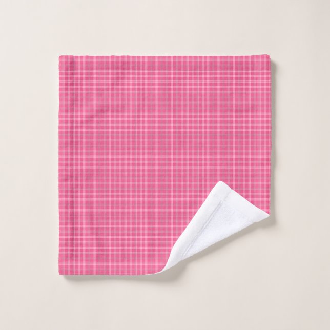 A set of pink gingham-patterned bath linens hangs  (Wash Cloth)