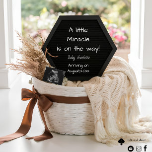 A simple neutral basket pregnancy announcement