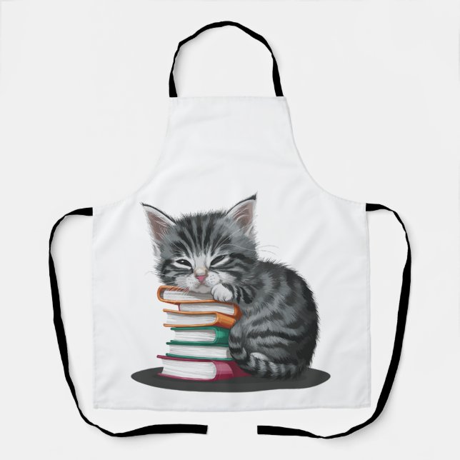 A sleepy kitten cuddled up with a stack of books. apron (Front)