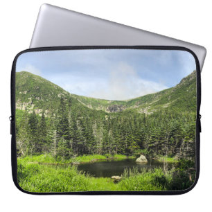 A small pond in the valley of the mountains in the laptop sleeve