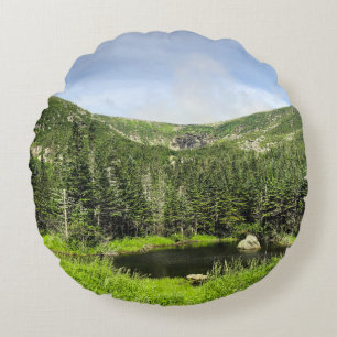A small pond in the valley of the mountains in the round cushion