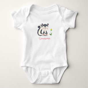 A Smiling Baby Skunk With a Yellow Flower Bodysuit