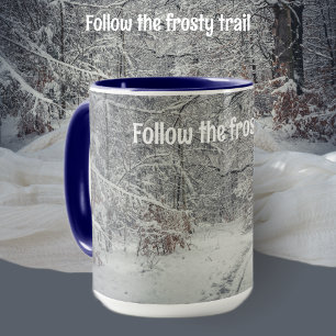 A snow-covered path through a winter forest mug