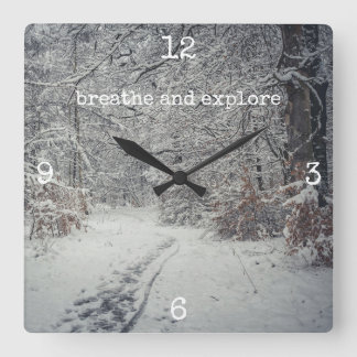 A snow-covered path through a winter forest square wall clock