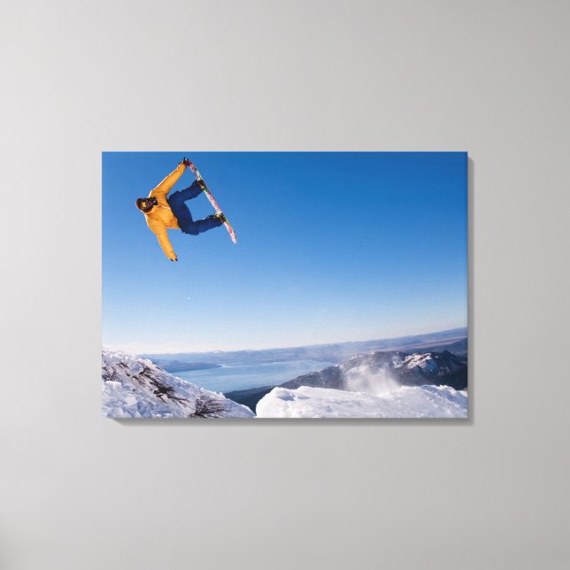 A snowboarder spins off a jump in Argentina Canvas Print (Front)