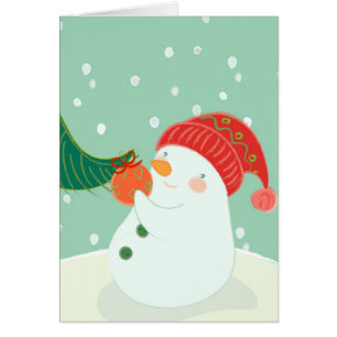A snowman hanging an ornament on a tree