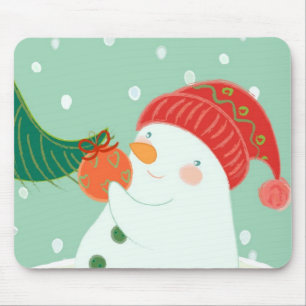 A snowman hanging an ornament on a tree mouse mat