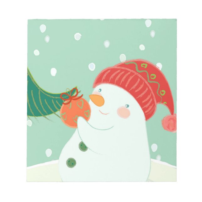A snowman hanging an ornament on a tree notepad (Front)