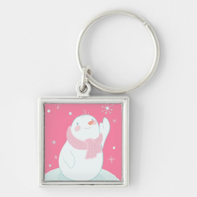 A snowman reaching for a falling snowflake key ring (Front)