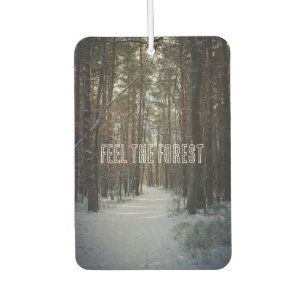A snowy trail in a winter pine forest car air freshener