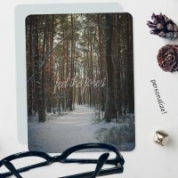 A snowy trail in a winter pine forest