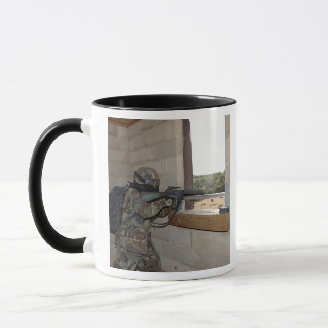 A soldier acts as an opposition force mug (Left)